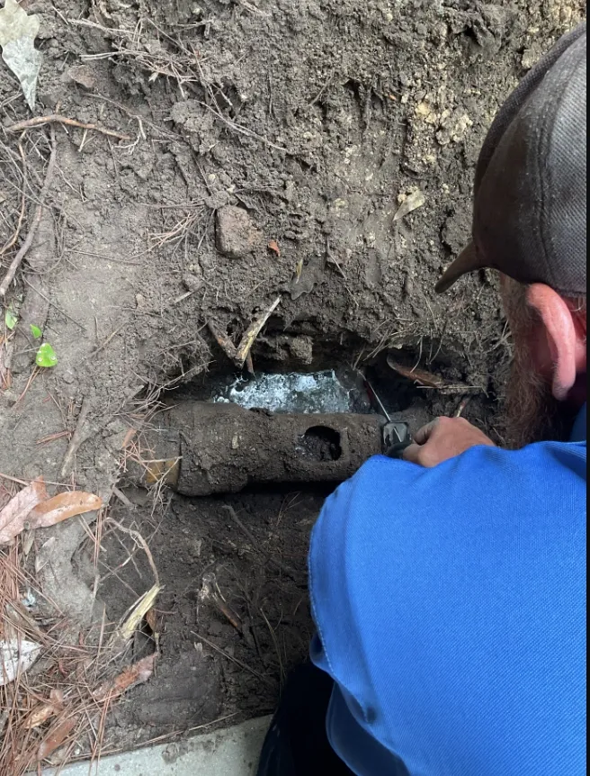 A new water or sewer line being installed in a yard.